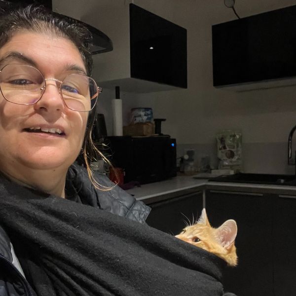 Rachel Perruchet souriante, tenant un chat roux dans ses bras